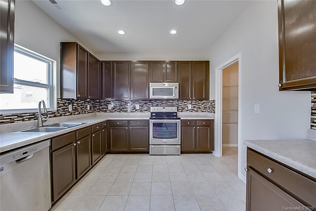 1022 Yellow Bee Road Indian Trail, NC 28079 - Photo 2 of 20 a kitchen with a stove sink and cabinets