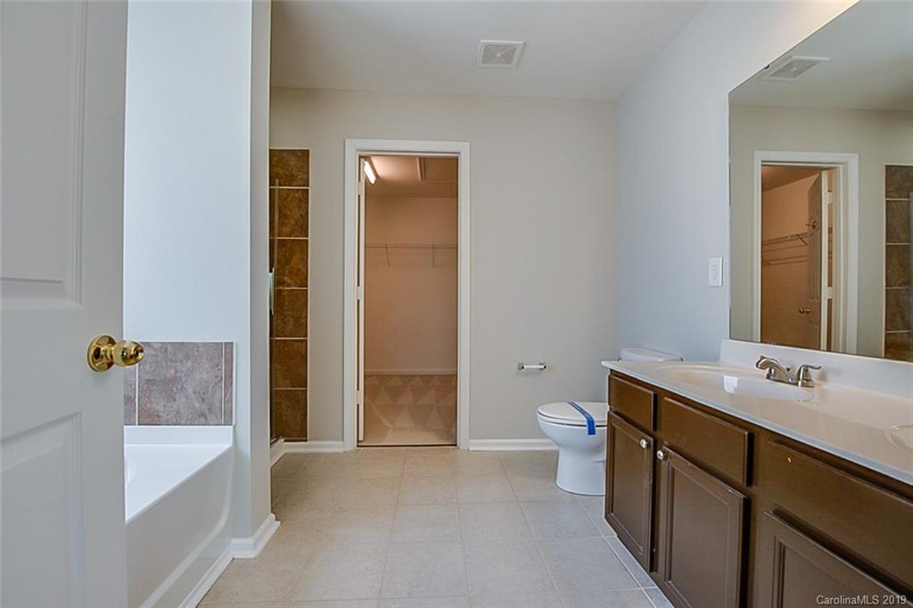 1022 Yellow Bee Road Indian Trail, NC 28079 - Photo 13 of 20 a bathroom with a sink a toilet and shower