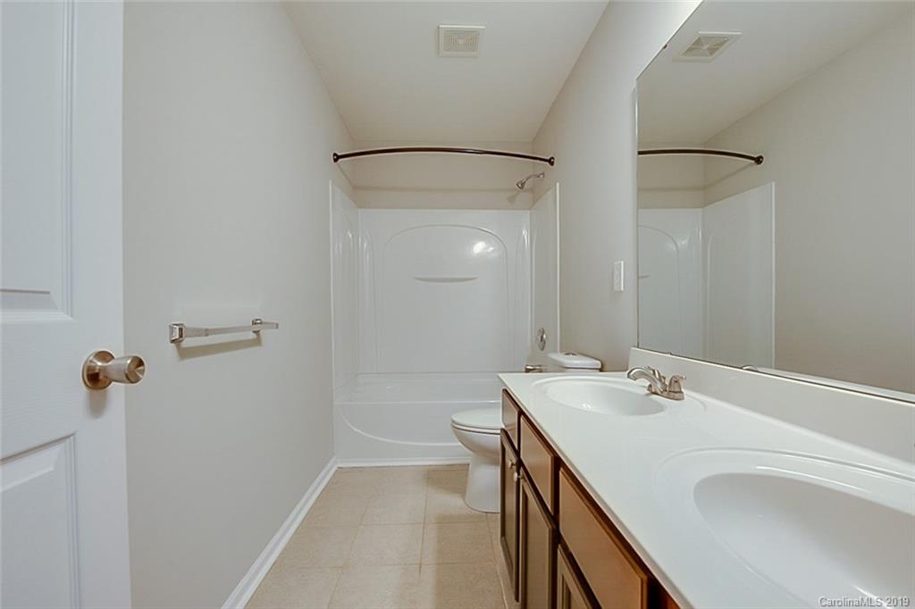 1022 Yellow Bee Road Indian Trail, NC 28079 - Photo 17 of 20 a bathroom with a sink a toilet and shower