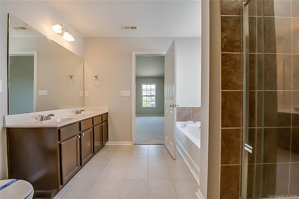 1022 Yellow Bee Road Indian Trail, NC 28079 - Photo 3 of 20 a bathroom with a tub sink and mirror