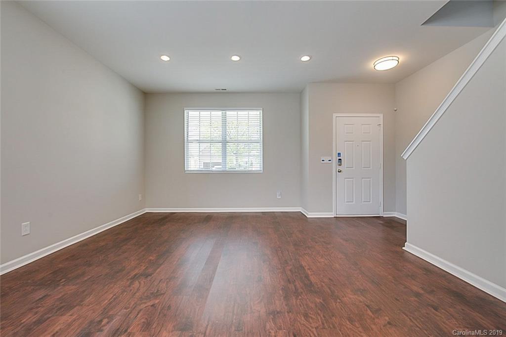 1022 Yellow Bee Road Indian Trail, NC 28079 - Photo 6 of 20 a view of an empty room with wooden floor and a window