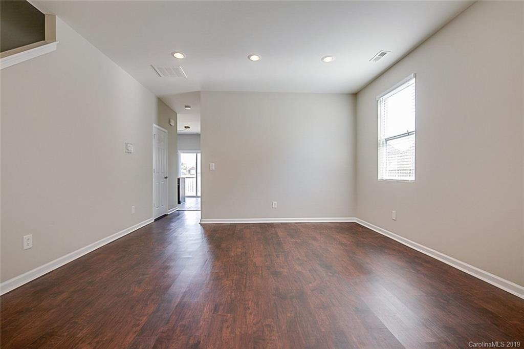 1022 Yellow Bee Road Indian Trail, NC 28079 - Photo 7 of 20 a view of an empty room with wooden floor and window
