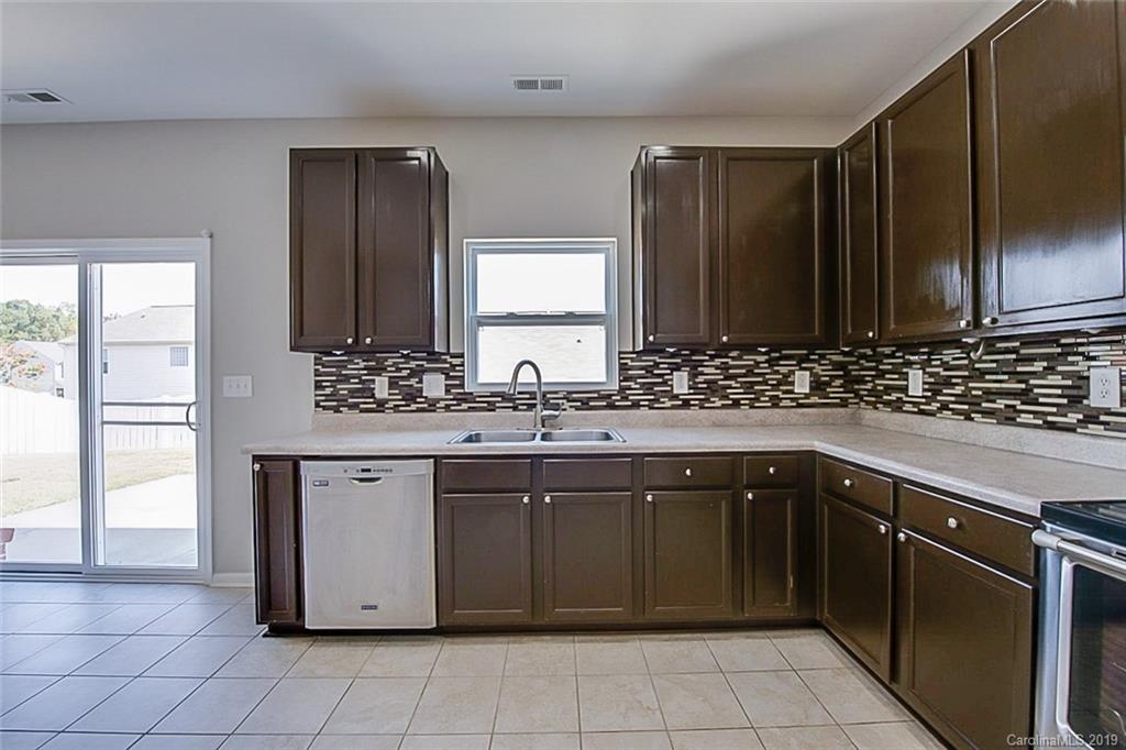 1022 Yellow Bee Road Indian Trail, NC 28079 - Photo 8 of 20 a kitchen with a sink stove and cabinets