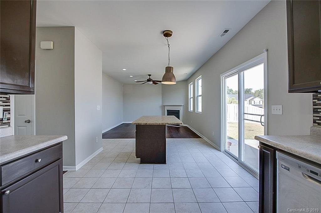 1022 Yellow Bee Road Indian Trail, NC 28079 - Photo 9 of 20 a kitchen with granite countertop a refrigerator and a sink