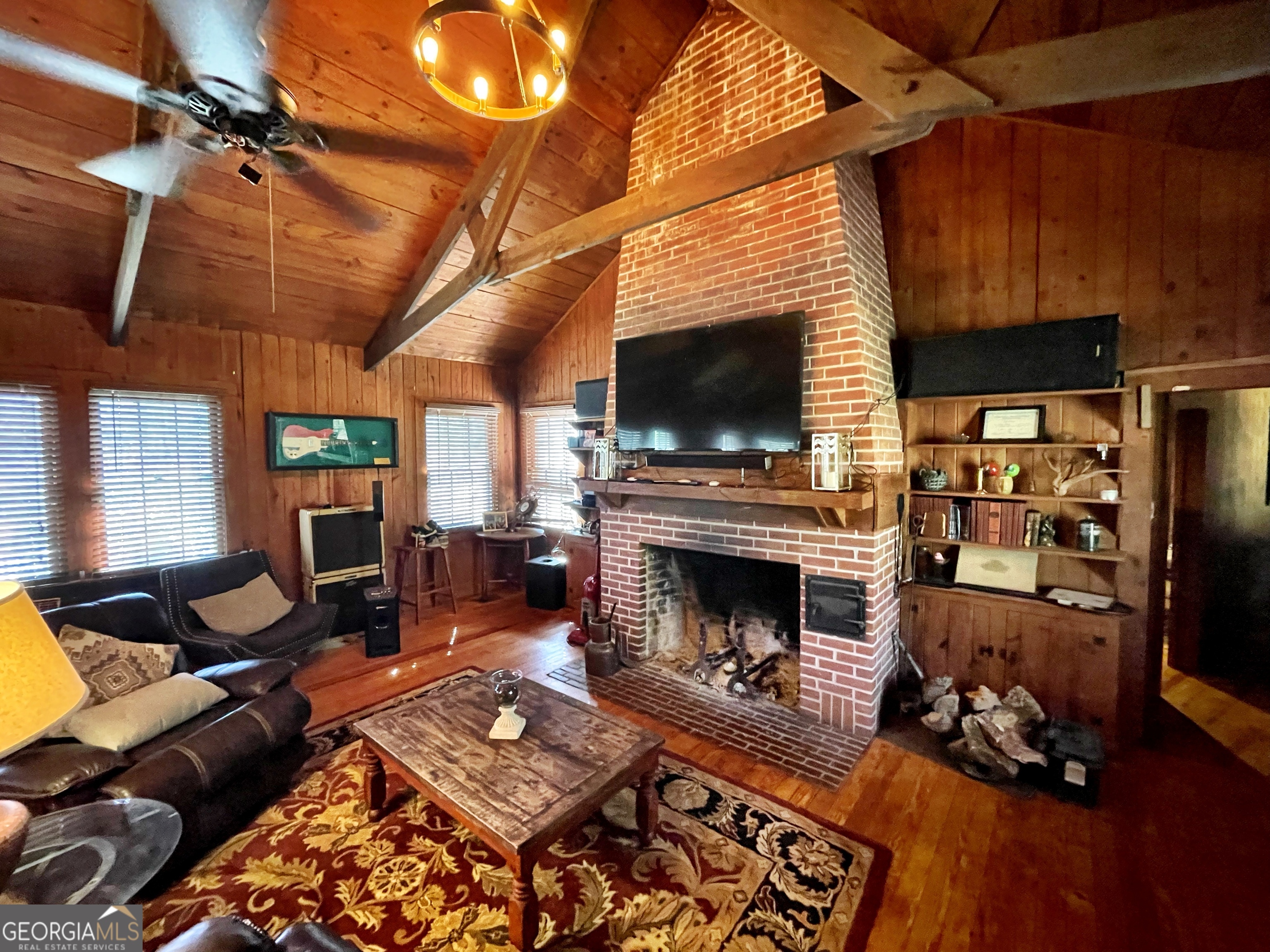 6591 Thomaston Road Macon, GA 31220 - Photo 3 of 30 a living room with furniture a flat screen tv and a fireplace