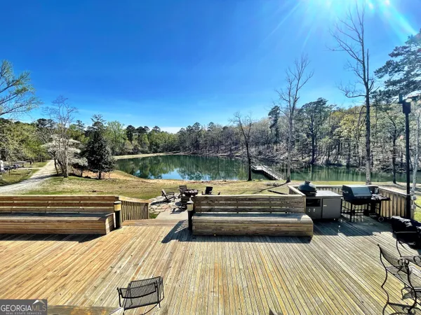 a view of a roof deck with couches and sky view