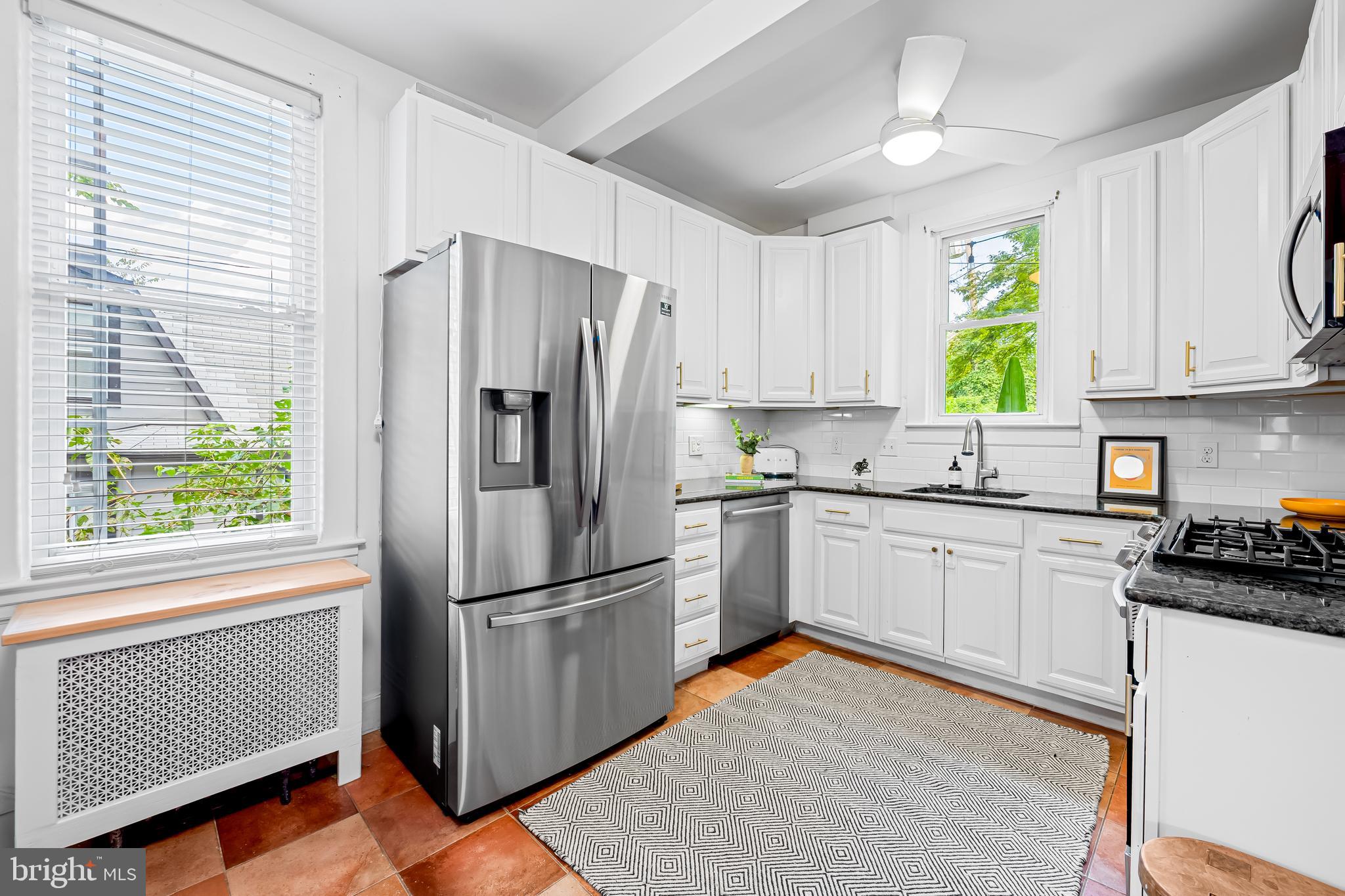 5009 Catalpha Road Baltimore, MD 21214 - Photo 13 of 38 a kitchen with stainless steel appliances granite countertop a refrigerator sink and cabinets