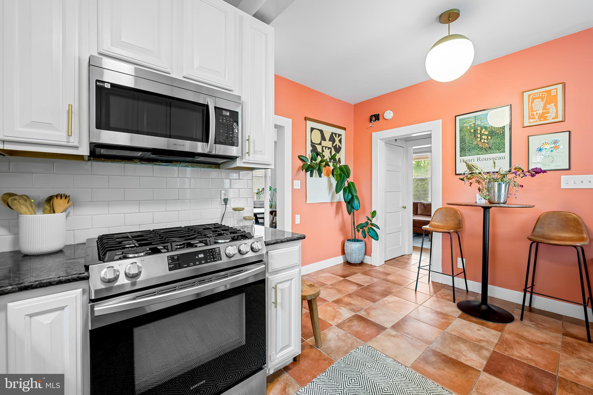 5009 Catalpha Road Baltimore, MD 21214 - Photo 15 of 38 a kitchen with stainless steel appliances granite countertop a stove and a microwave