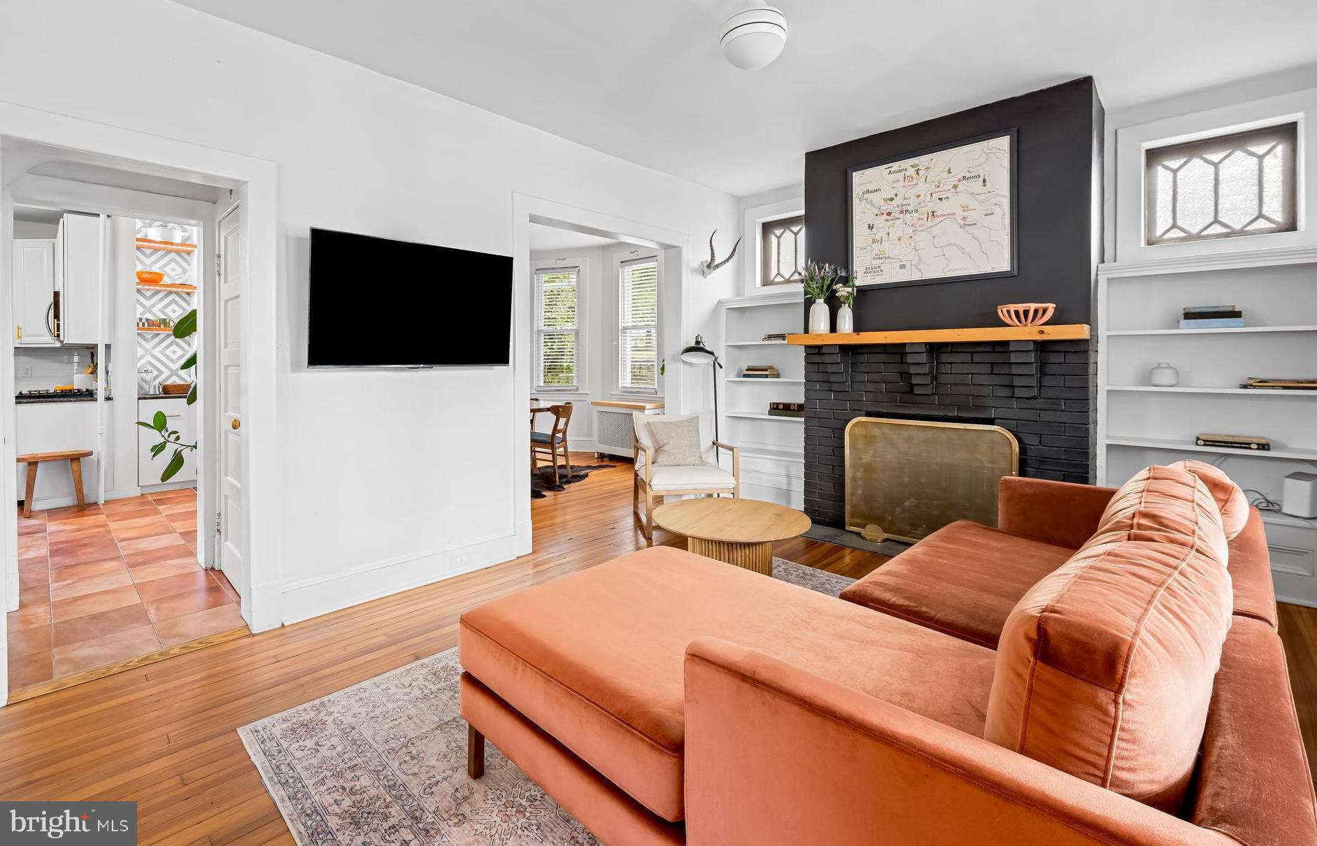 5009 Catalpha Road Baltimore, MD 21214 - Photo 2 of 38 a living room with fireplace furniture and a flat screen tv