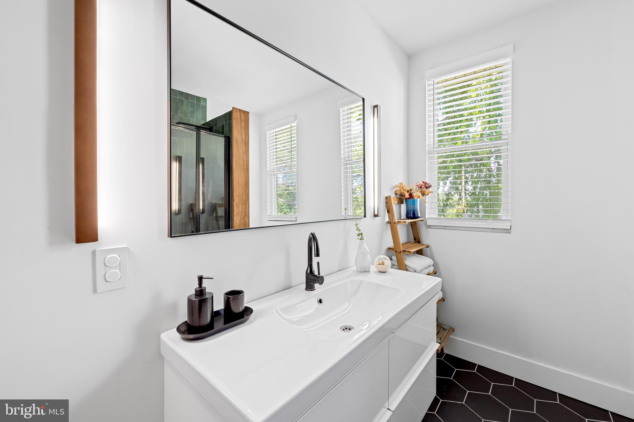 5009 Catalpha Road Baltimore, MD 21214 - Photo 24 of 38 a bathroom with a sink and a mirror