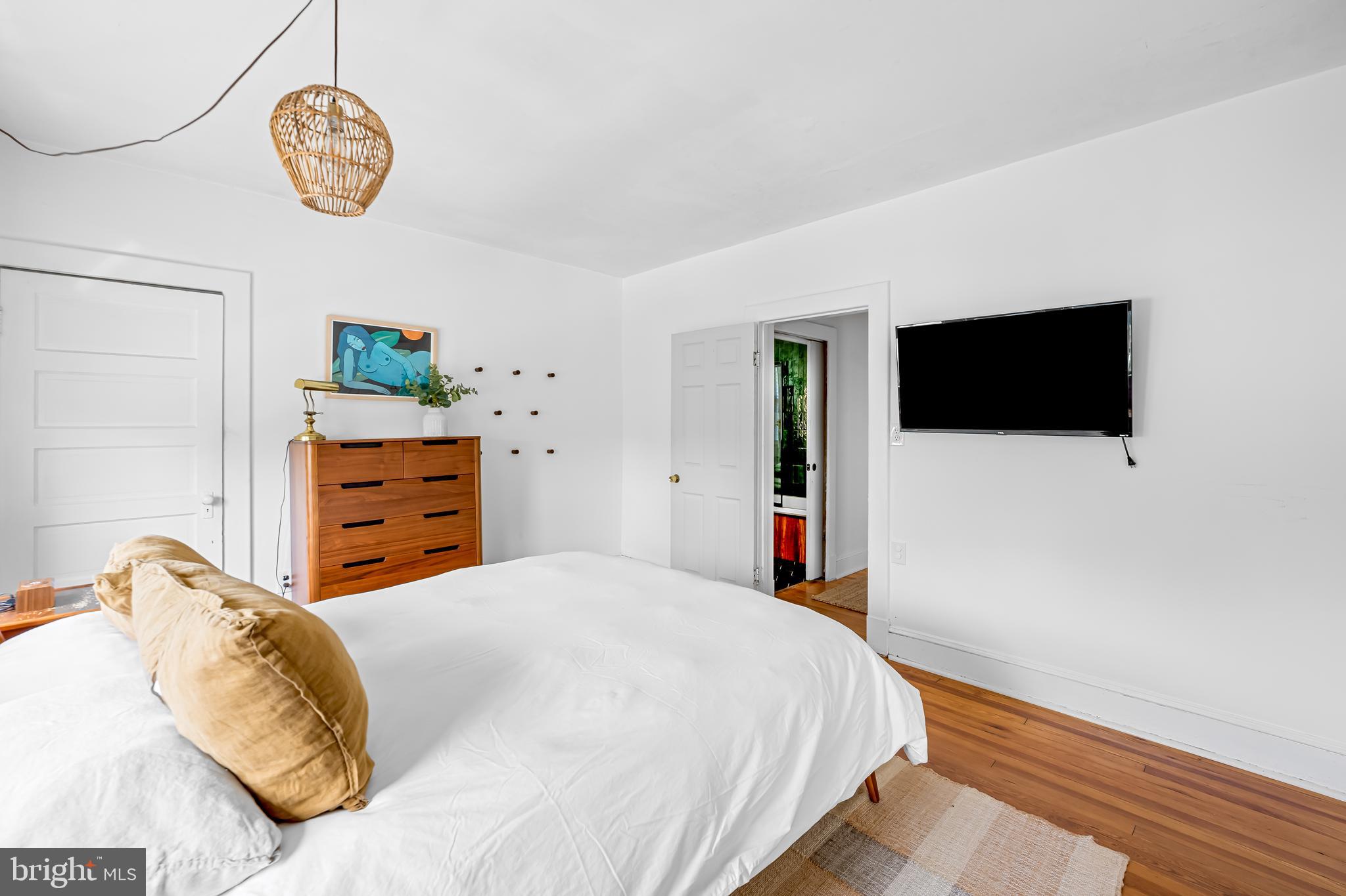 5009 Catalpha Road Baltimore, MD 21214 - Photo 28 of 38 a bedroom with a bed and a flat screen tv