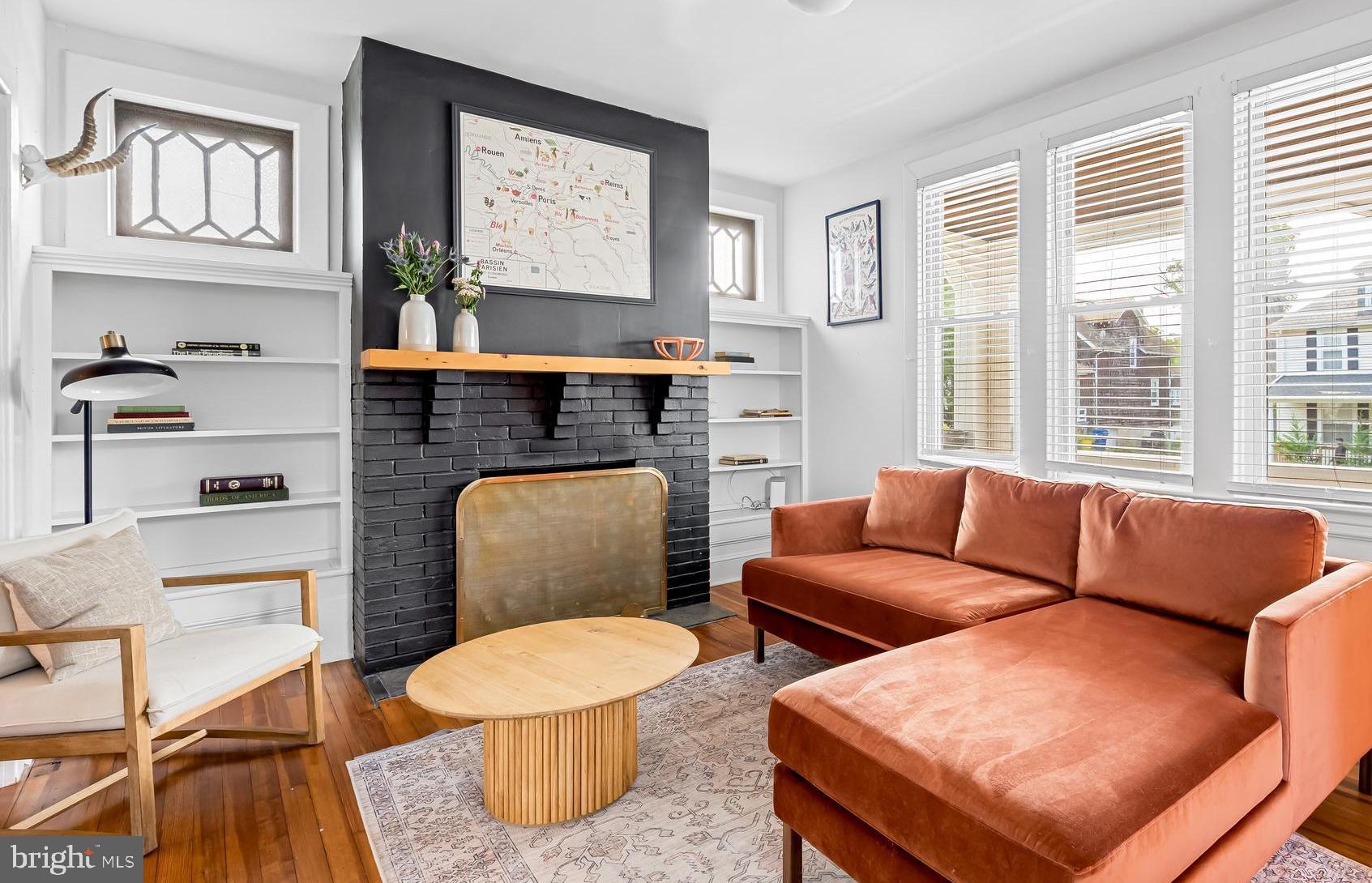 5009 Catalpha Road Baltimore, MD 21214 - Photo 3 of 38 a living room with furniture a flat screen tv and a fireplace