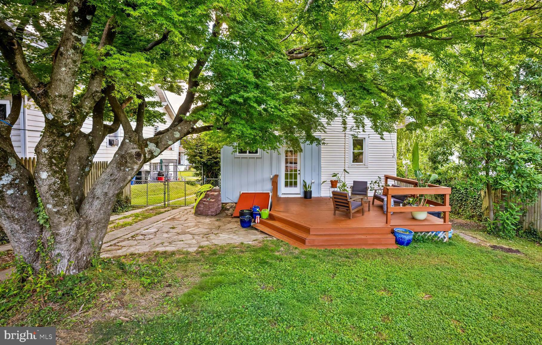 5009 Catalpha Road Baltimore, MD 21214 - Photo 31 of 38 a view of a backyard with wooden fence and a slide
