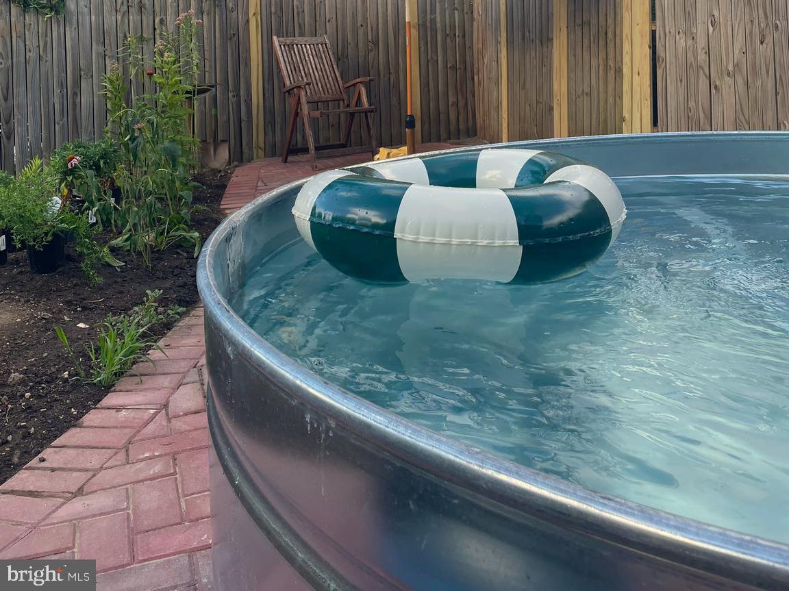 5009 Catalpha Road Baltimore, MD 21214 - Photo 34 of 38 a wooden bench sitting in middle of a backyard