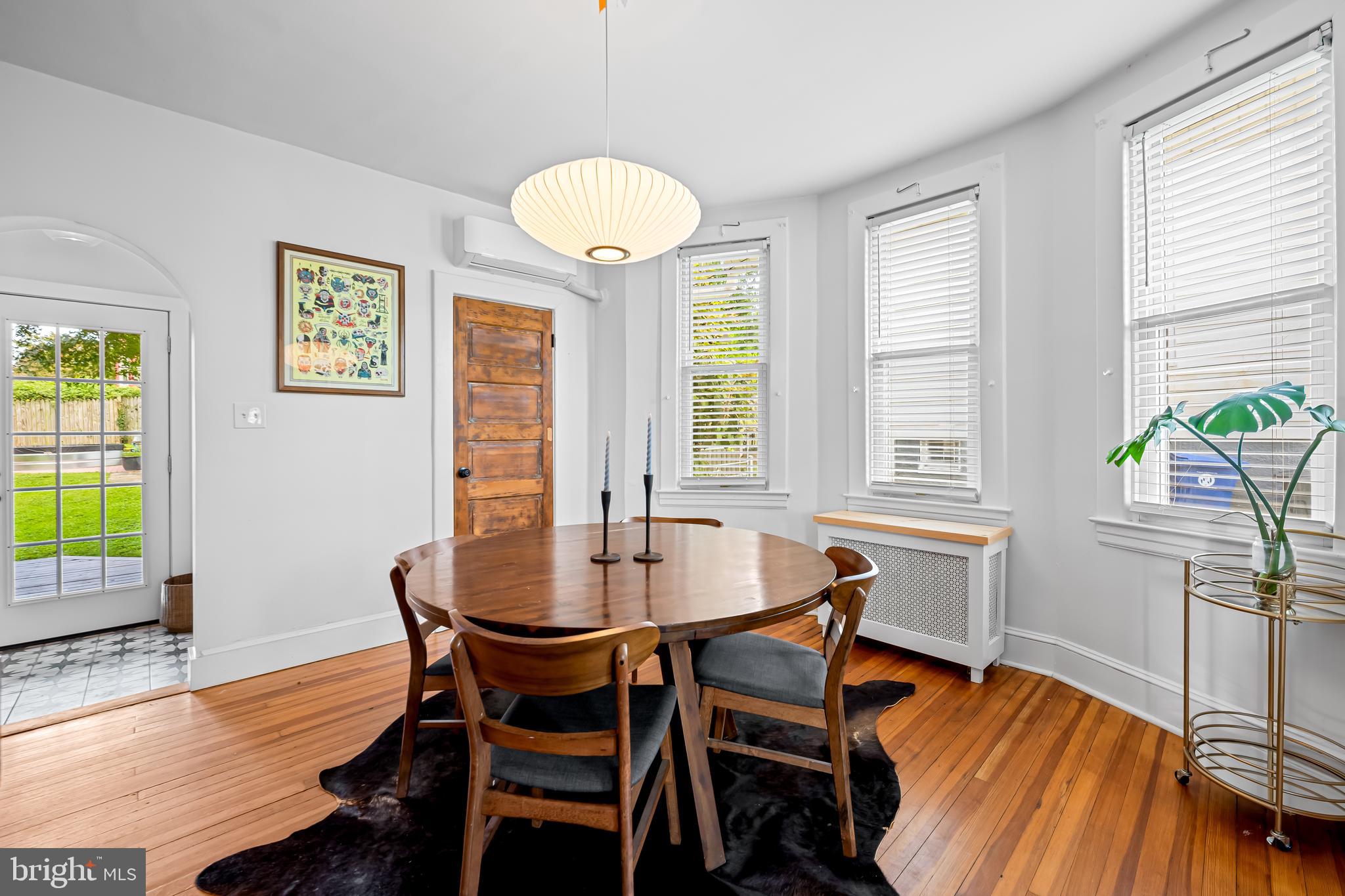 5009 Catalpha Road Baltimore, MD 21214 - Photo 7 of 38 a dining room with furniture a rug and wooden floor