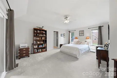 a bedroom with a large bed and a chandelier