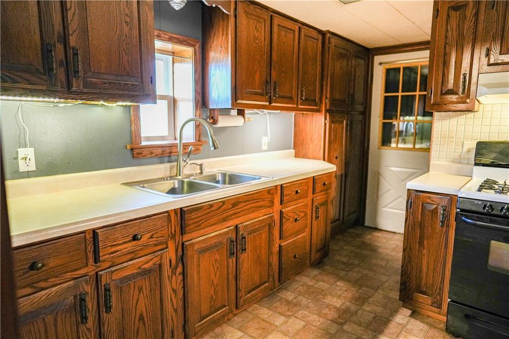 1390 Garretts Run Road Ford City, PA 16226 - Photo 6 of 24 a kitchen with stainless steel appliances granite countertop a sink stove and cabinets