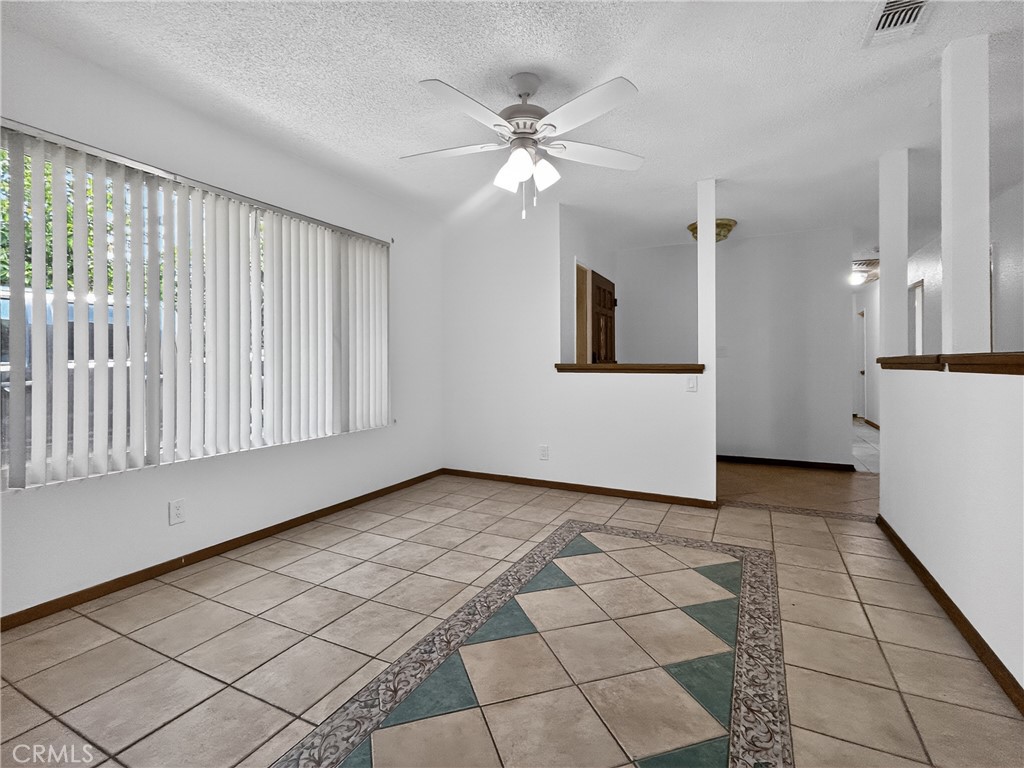 7451 Diamond Street Riverside, CA 92504 - Photo 2 of 31 a view of a livingroom with a ceiling fan and window