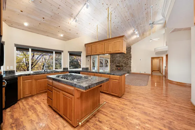 a kitchen with stainless steel appliances granite countertop a stove and a sink