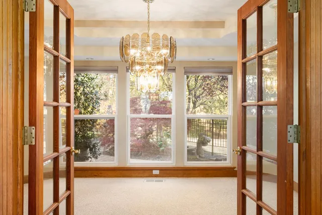 a view of a room with a large window and table