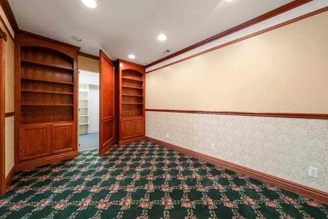 a view of an empty room with a window and a ceiling fan