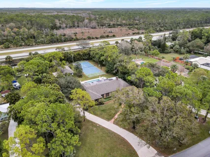 an aerial view of a house with a yard