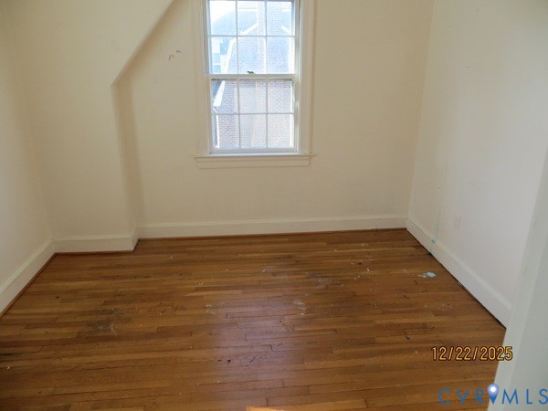 1124 Woodland Road Petersburg, VA 23805 - Photo 6 of 11 an empty room with wooden floor and windows