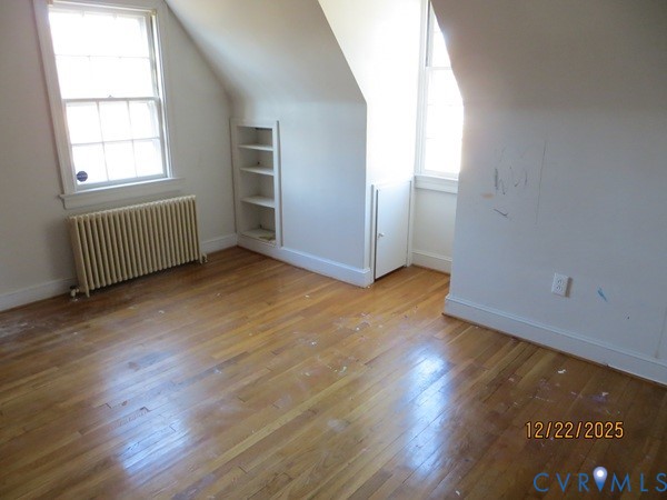 1124 Woodland Road Petersburg, VA 23805 - Photo 7 of 11 an empty room with wooden floor and windows
