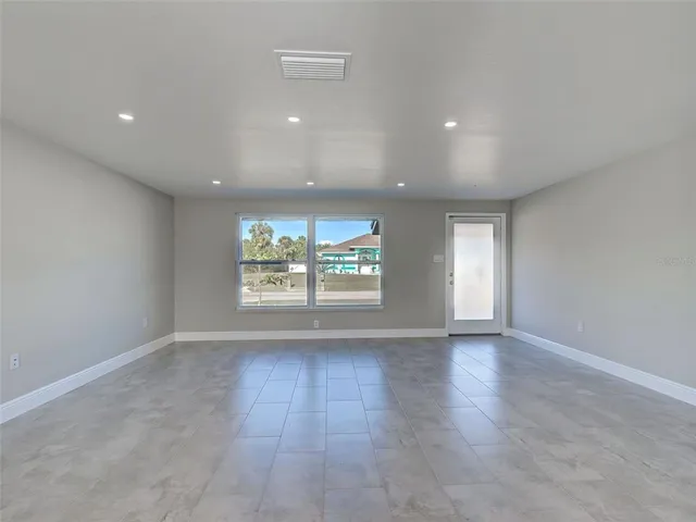 a view of a livingroom with a ceiling fan and window