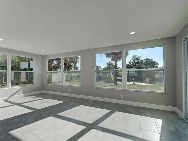 a view of an empty room with glass door and a window