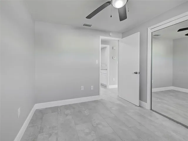 a view of room with a ceiling fan and window