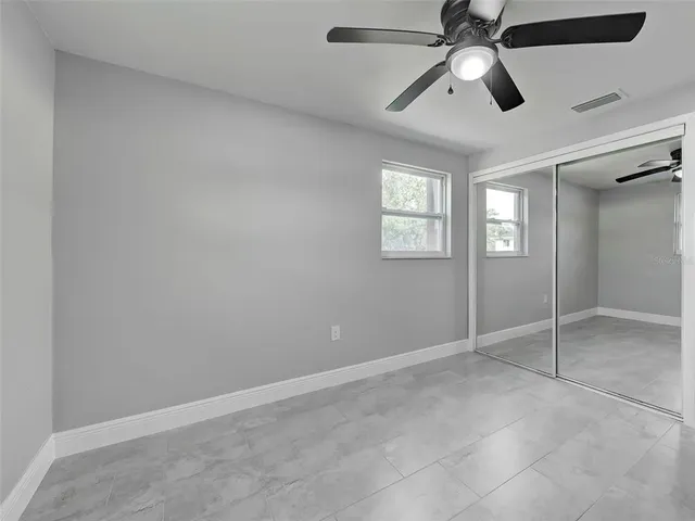 a spacious bedroom with a bed and a chandelier