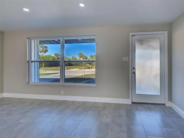 an empty room with windows and entrance