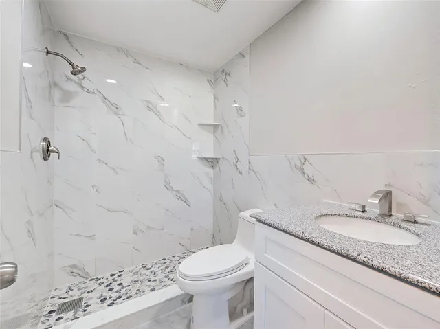 a view of a lake with houses in the back