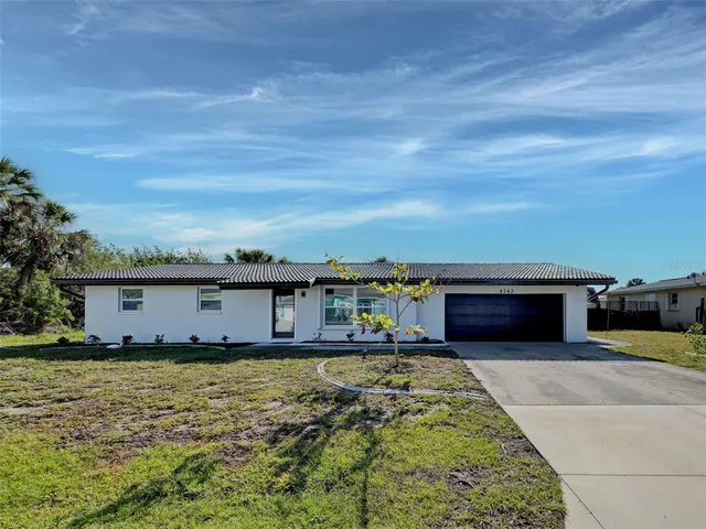 an aerial view of a houses with a lake view