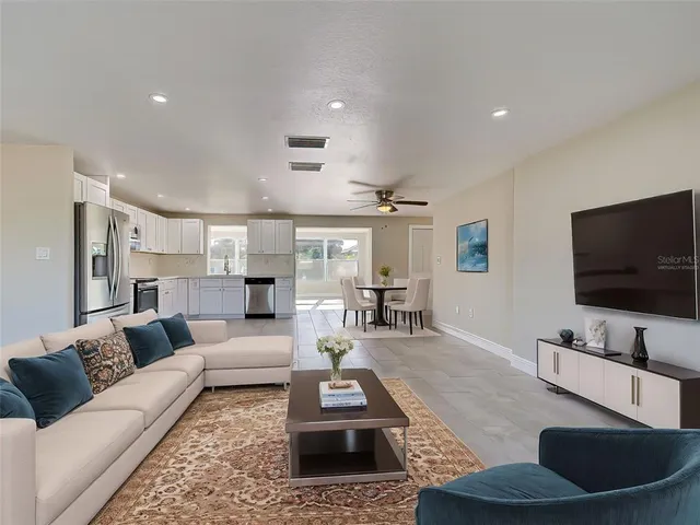 a kitchen with granite countertop white cabinets and stainless steel appliances