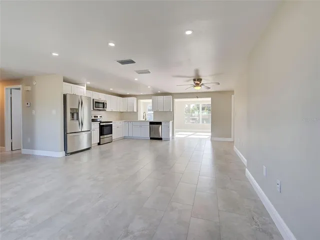 a kitchen with cabinets stainless steel appliances and a counter space