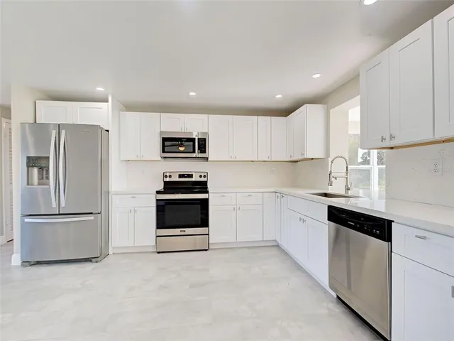 an empty room with wooden floor and a window