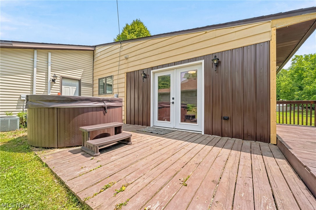 8160 Joyce Road Broadview Heights, OH 44147 - Photo 31 of 45 Exterior wood deck featuring a built-in hot tub, providing direct access to the interior via double French doors