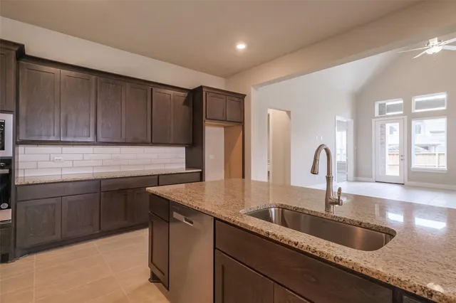 a kitchen with granite countertop cabinets and a stove top oven