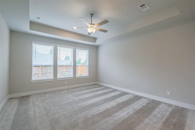 a view of an empty room with a ceiling fan