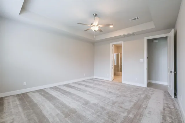 a view of an empty room with a ceiling fan