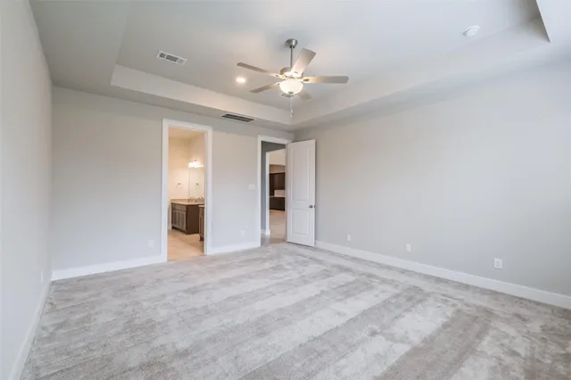 a bathroom with a granite countertop double vanity sink a mirror and a shower