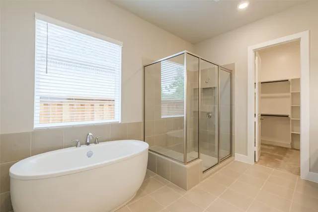 a bathroom with a glass shower door