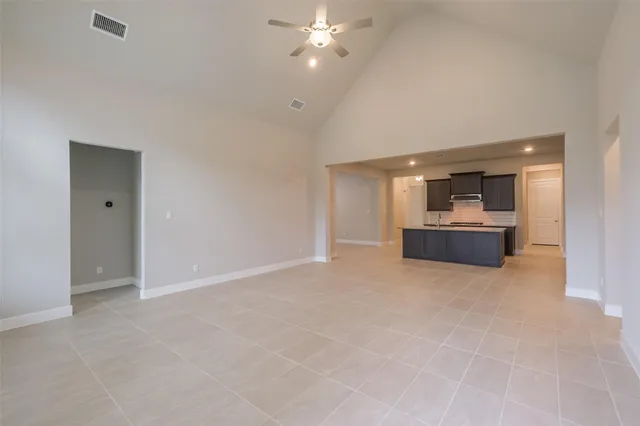 a view of a kitchen with a sink and a refrigerator