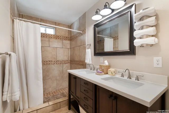 a bathroom with a sink vanity and a mirror