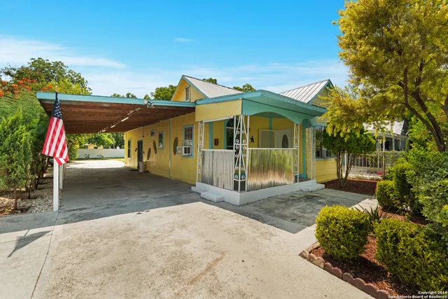 a view of a car park in front of a house