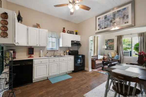 a kitchen with stainless steel appliances granite countertop a stove refrigerator and cabinets