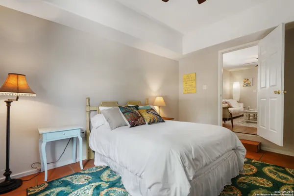 a bedroom with a bed and a lamp on table