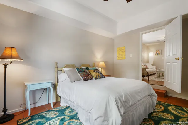 a bedroom with a bed and a lamp on table